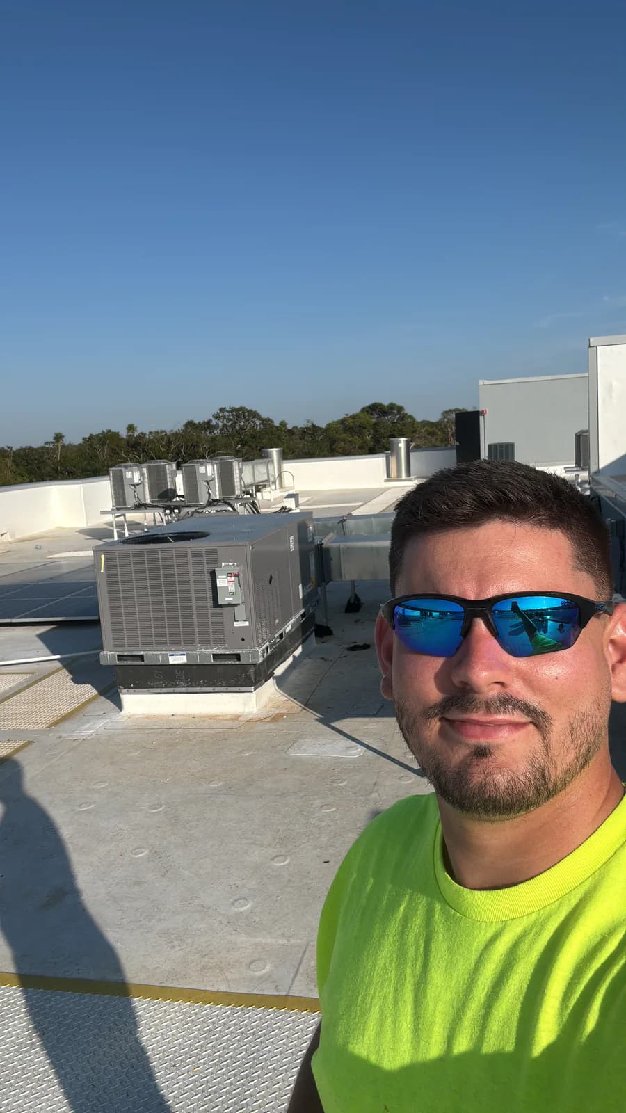 Rooftop HVAC service documentation with technician and commercial equipment